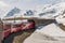 Red train from the company tunneling in the Alps