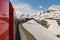 Red train from the company tunneling in the Alps.