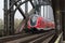 Red train on DeutschherrnbrÃ¼cke famous bridge in Frankfurt