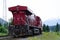 Red train driving through the rockies