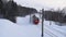 Red train rides through the snowy winter woods