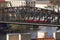 A red tram crossing a steel bridge in Prague