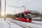 Red tram rushes through the city in winter motion blur effect