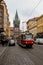 Red tram, tourists and Henry tower in Prague