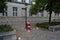 Red trash bin on the street with an inscription in German saying I make dirty business.