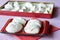 Red tray and box of homemade meringues