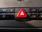 Red triangular car alarm button on the dashboard.