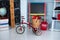 Red tricycle with basket apples. Back to school. Elementary school. Chalkboard, Books, globe in classroom. Teachers Day. Empty cla