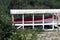 Red Trim Aluminum Boat In Boat Shelter On Beach