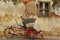Red trishaw in front of weathered wall