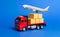 A red truck with boxes and cargo plane. Goods transportation services company. Logistics and infrastructure. Warehousing