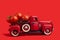 The red truck delivers fresh tomatoes. Vintage red toy truck on a red background