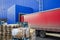 Red truck discharging goods in warehouse