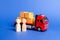 A red truck loaded with boxes near a customer buyer and seller. Business and commerce. Negotiations on supply of goods. Services