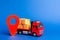 A red truck loaded with boxes and a red pointer location. Services transportation of goods, products, logistics and infrastructure