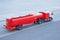 Red truck with a tank and a trailer of aviation fuel on the airport airfield