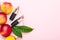 Red tubes of lipstick with bright juicy ripe nectarines on pink stand copmposition, peaches on a pink background. Summer fruits,
