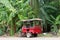 Red tuktuk in jungle, Cambodia