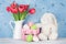 Red tulip flowers, eggs and easter rabbit toy