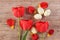 Red tulips cheerful Easter arrangement on light brown background