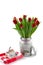 Red tulips in a milk churn