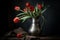 Red tulips in a vintage pewter jug. Dark and moody still life