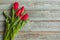 Red tulips on wooden background. Valentine`s day concept. 8 march. Mother day concept. Top view