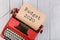 Red typewriter with the text "Budget 2020" on white wooden background