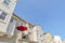 Red umbrella on a balcony of a townhouse with cream wall exterior