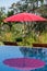 Red umbrella reflection in pool