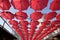 Red umbrellas against the blue sky. View from below. Abstract background with red umbrellas.