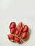 Red unshelled peanuts on a white back ground