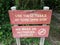 Red use these trails at your own risk sign and no bikes or motorized vehicles allowed sign near trail