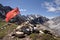 Red USSR flag at the top of mountain among stones