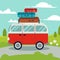 A red van on the road.Above of the red van have many bag for a good trip.A red van go to the trip on the road and have natural