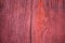 Red varnished aged grunge messy wooden background