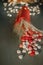 A red vase and heart shaped glazed chocolates on an old table. Blurred background with yellow bokeh. Top view.