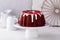 Red velvet bundt cake with cream cheese frosting and cake crumbs