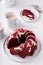 Red velvet bundt cake with cream cheese frosting and cake crumbs