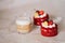 red velvet cakes, portioned, decorated with cherries and strawberries. transparent mug of cappuccino with a cinnamon stick. delici