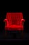 Red velvet chair on black background