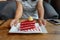 Red velvet cheese cake on white dish in woman hands serving