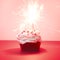 Red velvet cupcake with bengal lights on red background, red muffin. Square image. Valentine`s or birthday card. Magic sparks lig