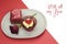 Red velvet cupcake, gift and rose bud dining table setting with love message for Valentines Day