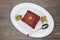 Red Velvet, fresh delicious diet cake with berry Physalis at Dukan Diet on a porcelain plate with a spoon on a wooden background