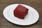 Red Velvet, fresh delicious diet cake at Dukan Diet on a porcelain plate on a wooden background.