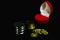 Red velvet gift box for a ring on a black background with coins of different denominations, symbolizing a marriage of convenience,