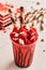 Red velvet Milkshake with straw and cake served in glass isolated on table top view healthy morning drink