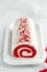 Red Velvet roll cake for Christmas with cream cheese and coconut flakes