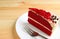 Red Velvet Shortcake with Cream Cheese Frosting on White Plate Served on Wooden Table